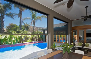 Outdoor living area featuring zip screens and outdoor fans.
